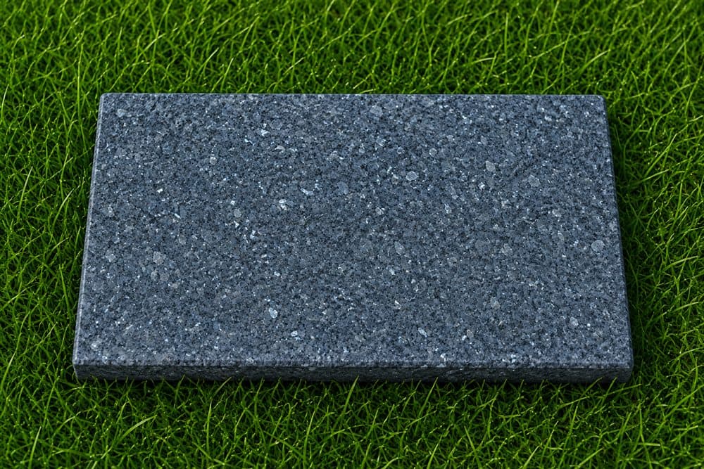 Blue Pearl granite slab photographed on grass